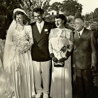 Wedding photo of the young couple with his parents.