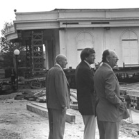Three men observe the progress as Le Petite Trianon is being moved to a new location. On the right, closest to the camera, is Dr. Robert Smithwick, the District's first Board Chairperson. In the center is Dr. A. Robert DeHart, De Anza's first President. The man on the left has not been identified. Image taken in the late 1960s.
