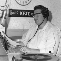 John Davis announcing at the broadcast desk of KFJC in the basement of Foothill College in Mountain View. 